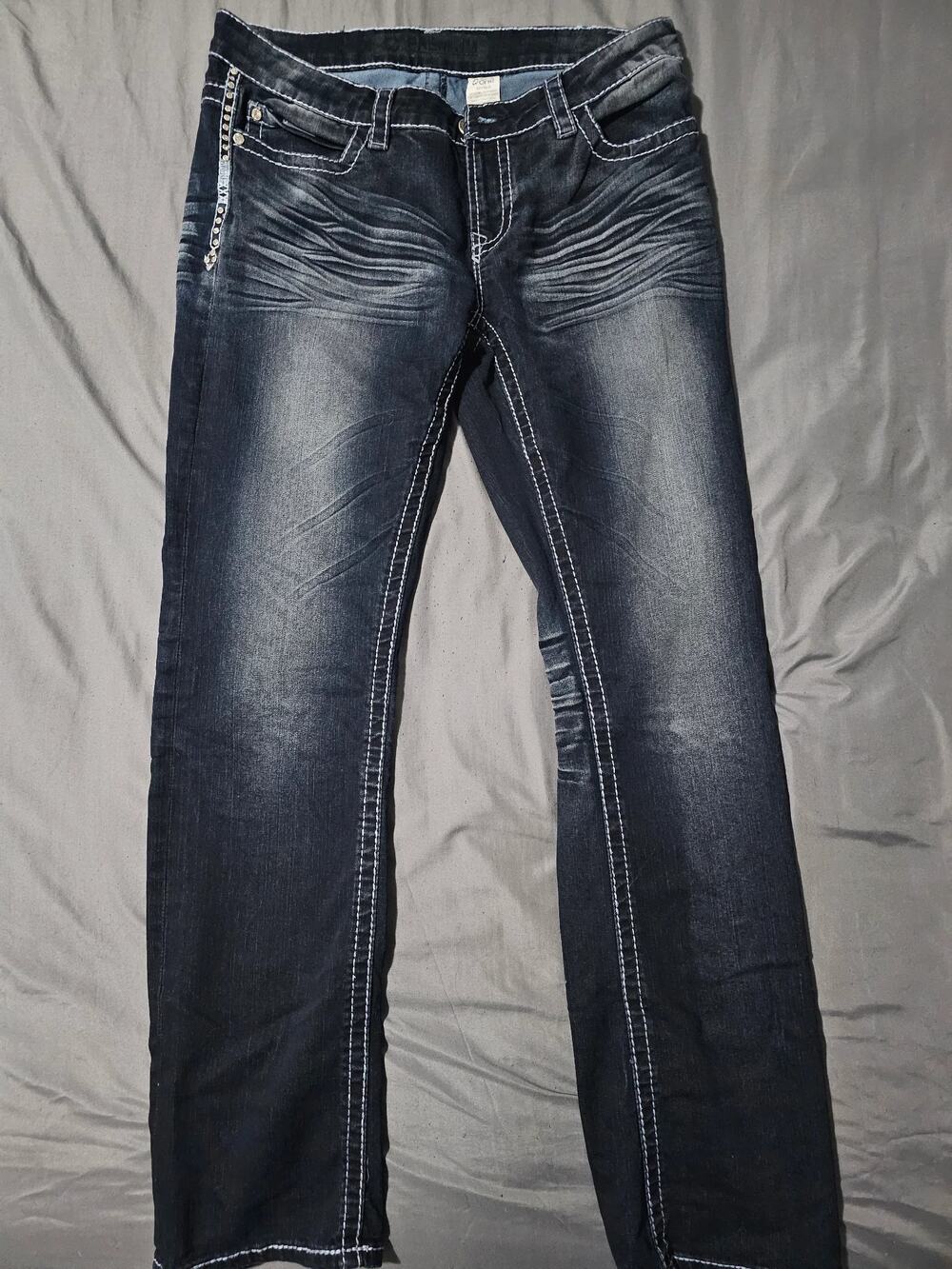 Dark wash jeans with contrast stitching rhinestone cross wing back pockets